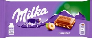 MILKA Czekolada mleczna z kawałkami orzechów laskowych 100g (pakowane 22 szt.)